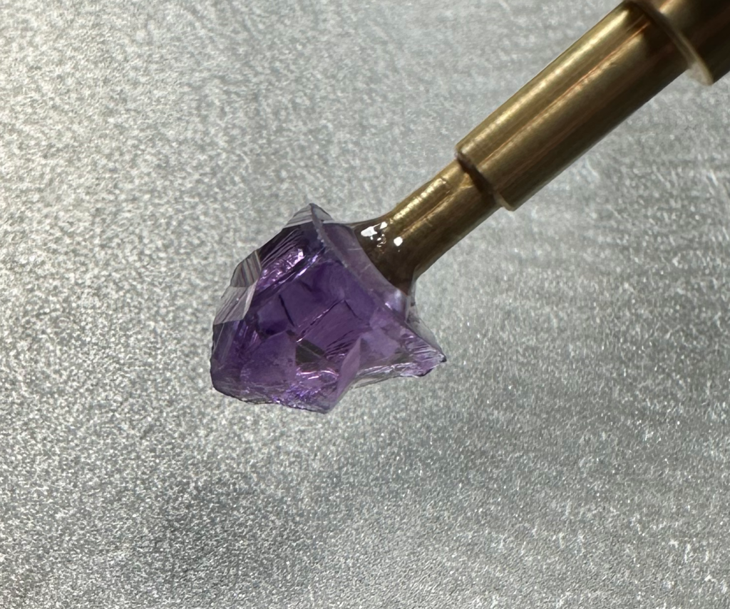 Amethyst from Brazil dopped and ready to facet.